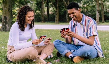 https://www.pexels.com/photo/man-and-woman-sitting-on-grass-playing-cards-2981571/