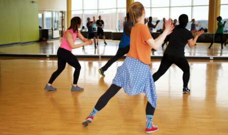 women dancing near mirror