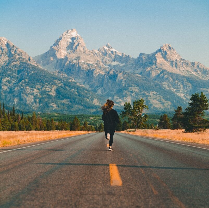 woman walking on road during daytime